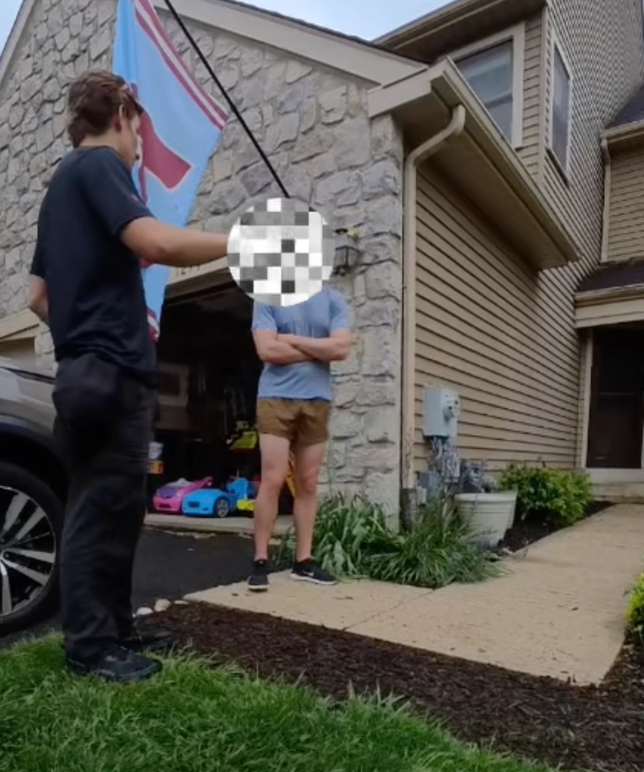 A sales representative speaking with a homeowner outside their home